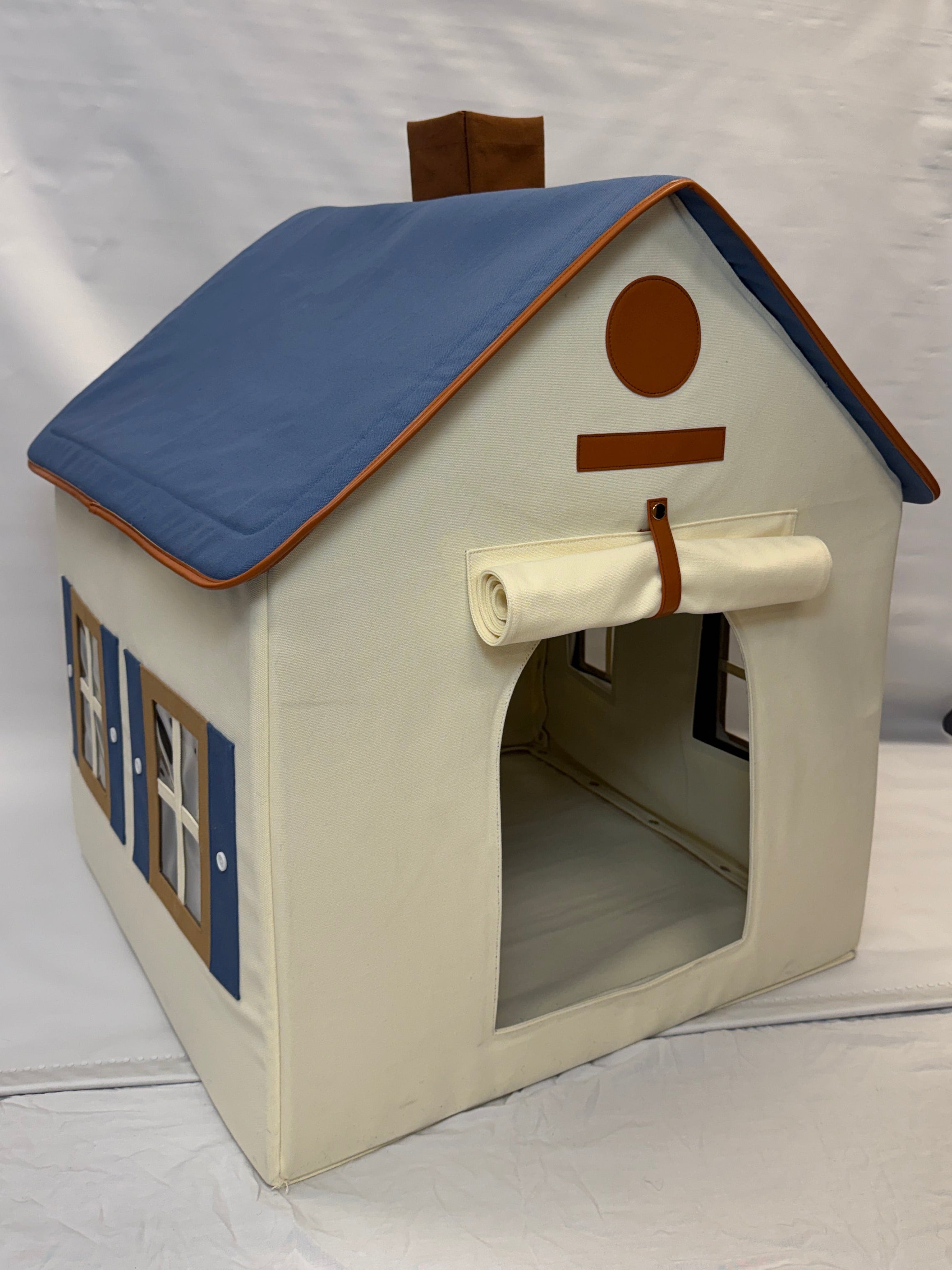 Cat house with blue roof and beige body on a white background